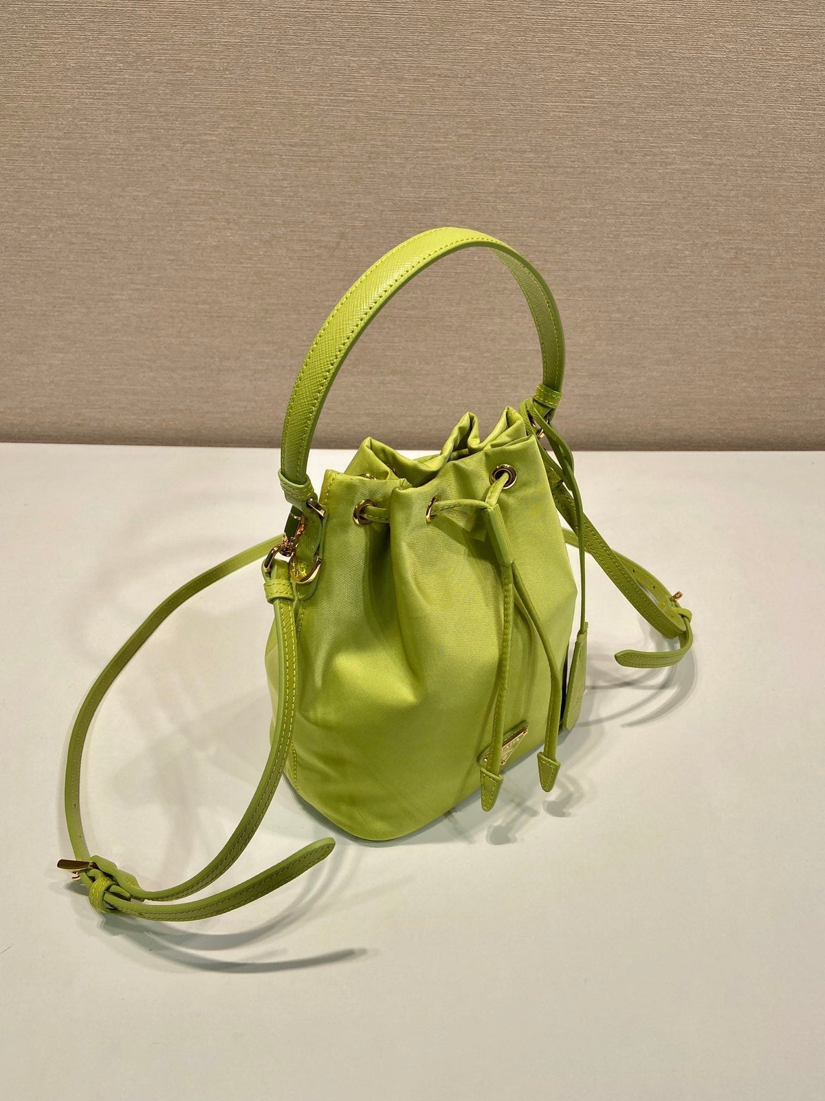 BUCKET BAG 19 IN APPLE GREEN RE-NYLON AND SAFFIANO LEATHER HANDLE
