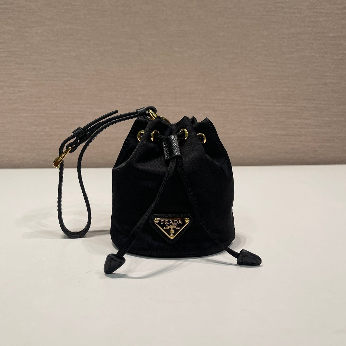 MINI BUCKET BAG 10 IN BLACK RE-NYLON AND SAFFIANO LEATHER STRAP
