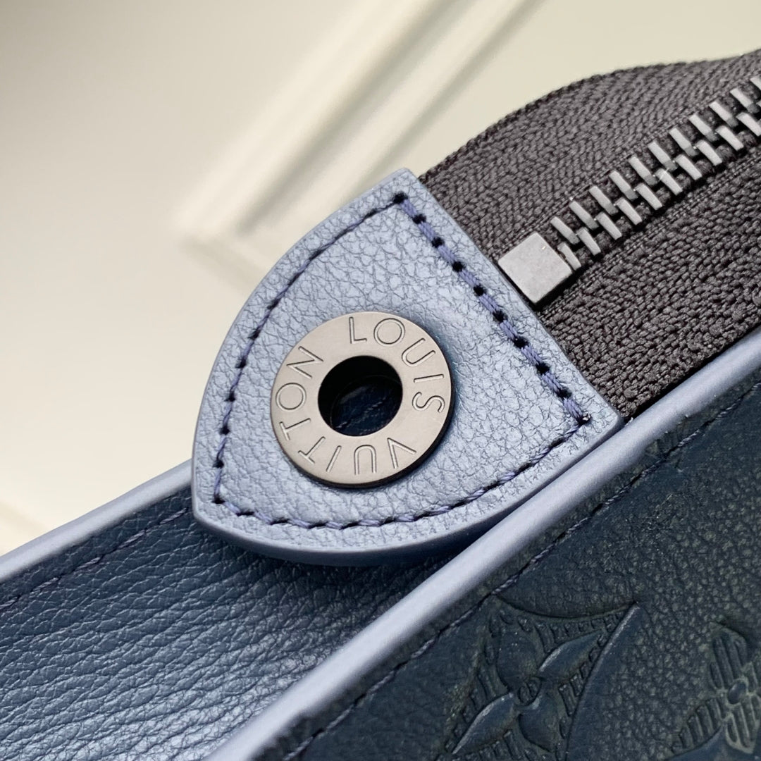 POCHETTE VOYAGE 27 IN DARK BLUE MONOGRAM ECLIPSE CALFSKIN EMBOSSED LOGO